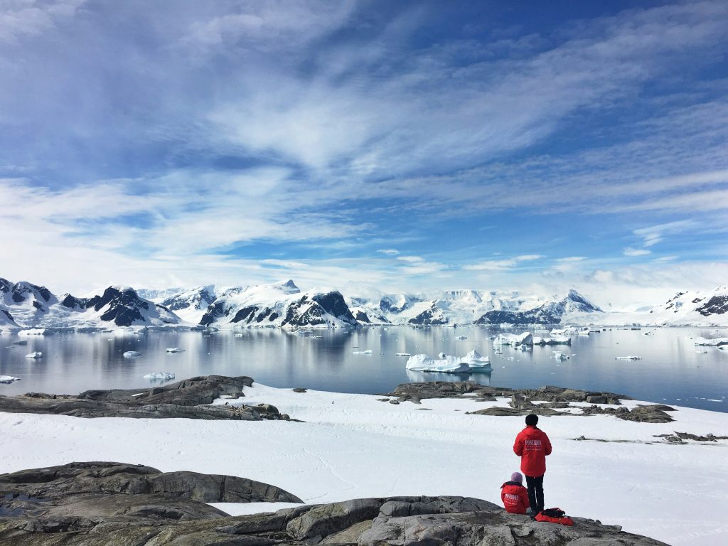 cassie-matias-IkJC9YAar-8-unsplash Two people standing on snow field in Antarctica